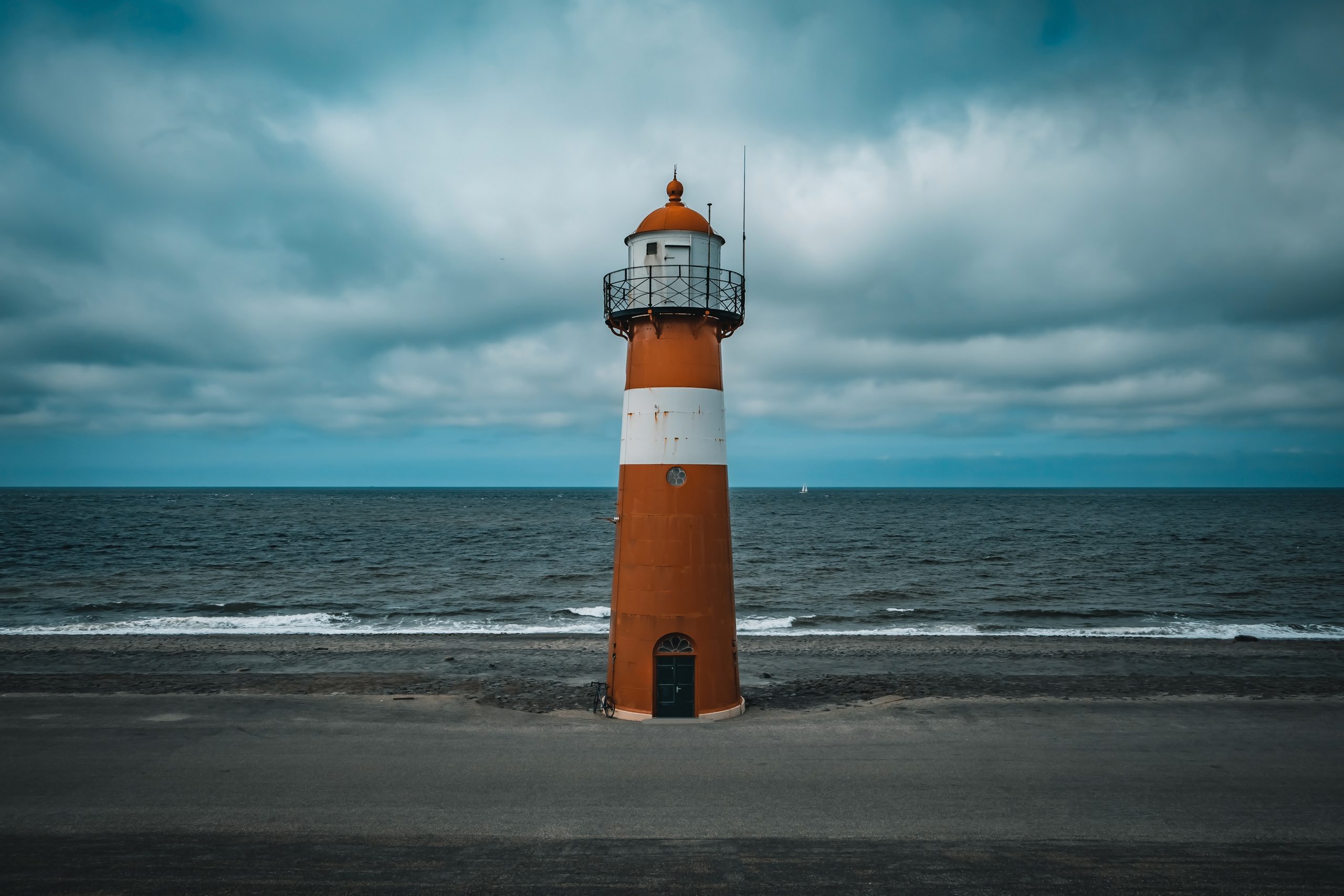 tall lighthouse north sea cloudy sky scaled -